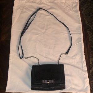 Black clutch with magnetic button closure